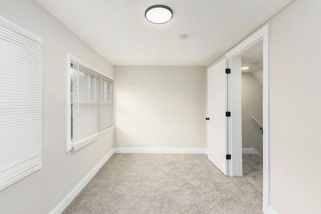 spare room with light colored carpet