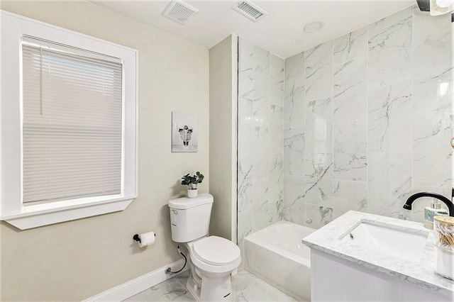 full bathroom with tiled shower / bath, vanity, and toilet