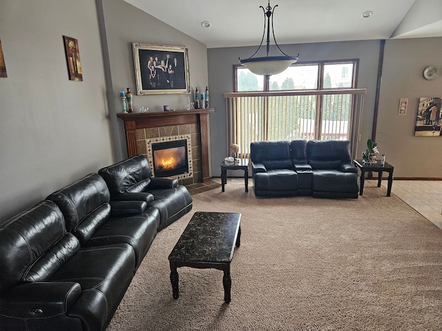 tiled living room featuring a tile fireplace and lofted ceiling