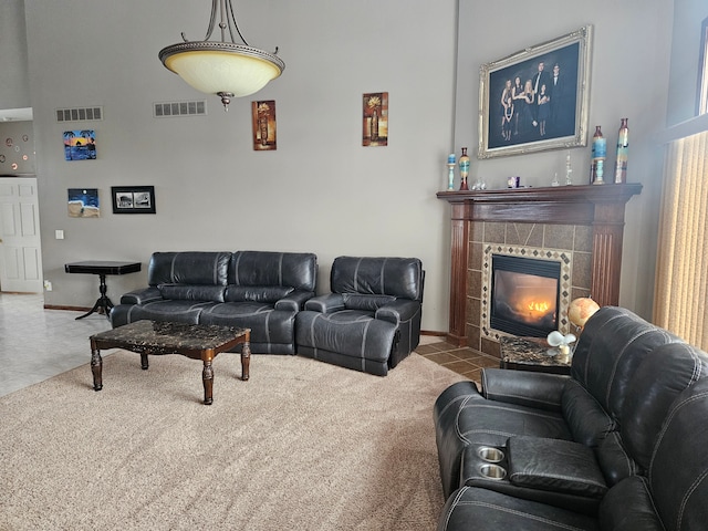 living room with tile patterned floors and a fireplace