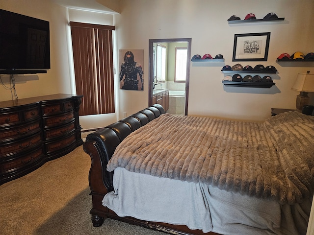 bedroom with ensuite bathroom and carpet flooring