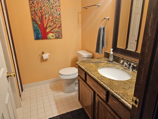 bathroom with vanity, tile patterned flooring, and toilet