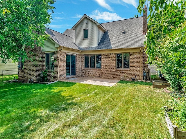 back of house featuring a lawn and a patio