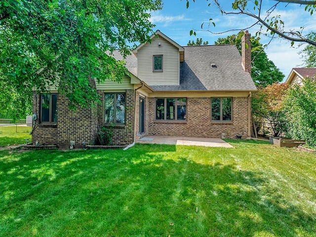 back of house with a patio and a lawn