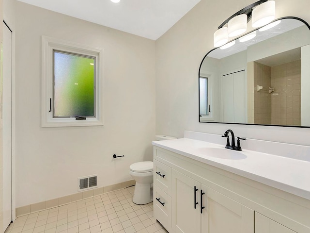 bathroom with vanity, a shower, tile patterned floors, and toilet