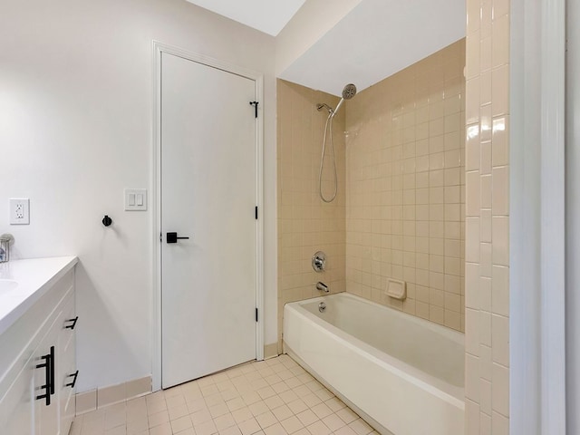 bathroom with tile patterned flooring, vanity, and tiled shower / bath combo