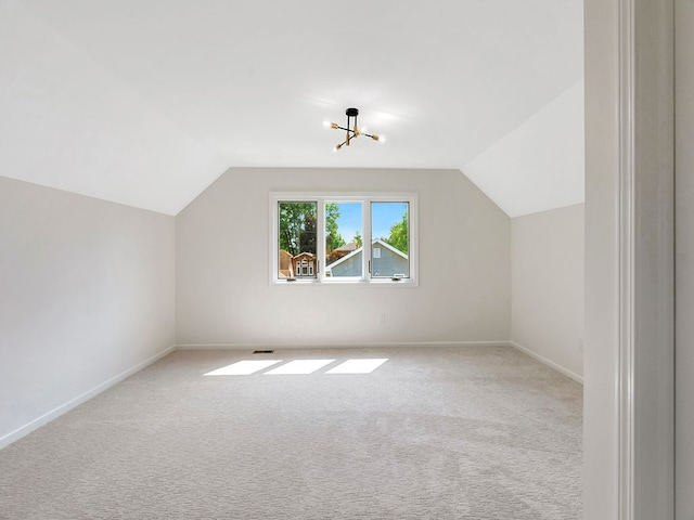 bonus room featuring lofted ceiling and light carpet