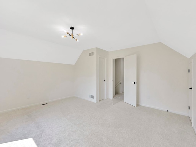 additional living space with lofted ceiling, light colored carpet, and a notable chandelier