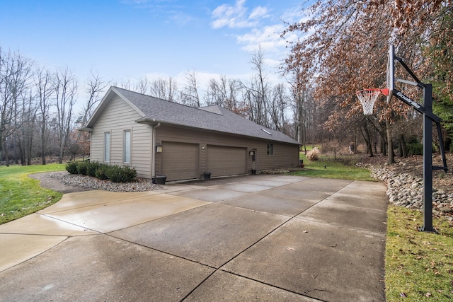 exterior space featuring a garage and a lawn