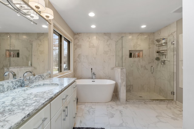 bathroom with vanity and independent shower and bath