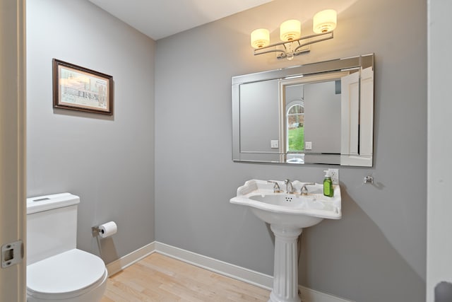 bathroom featuring hardwood / wood-style flooring and toilet