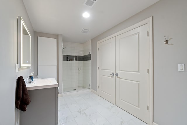 bathroom with vanity and a shower with door