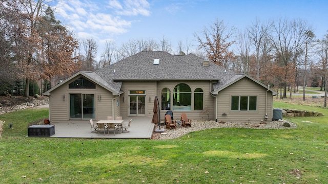 rear view of house featuring a yard