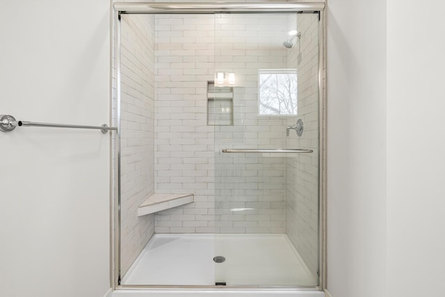 bathroom with a shower with shower door