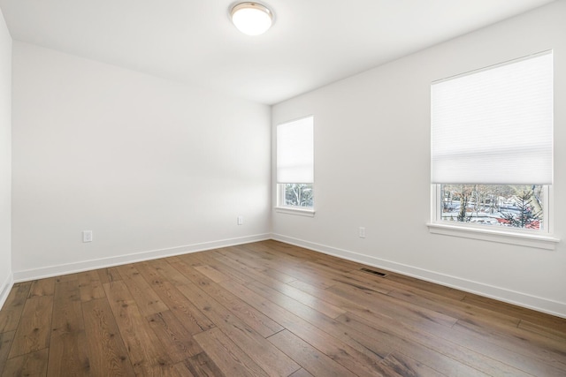 unfurnished room featuring wood-type flooring