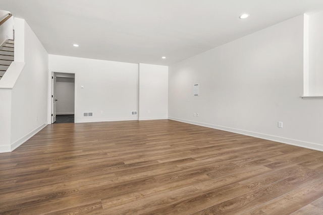 unfurnished room with dark hardwood / wood-style flooring