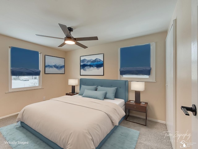 bedroom featuring light carpet and ceiling fan