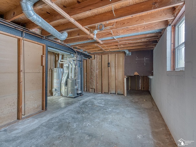 basement featuring heating unit and water heater