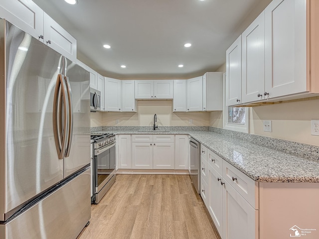 kitchen with white cabinetry and appliances with stainless steel finishes