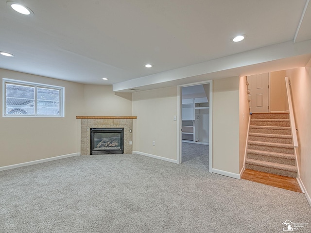 unfurnished living room with light colored carpet and a fireplace