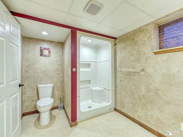 bathroom with a drop ceiling and toilet