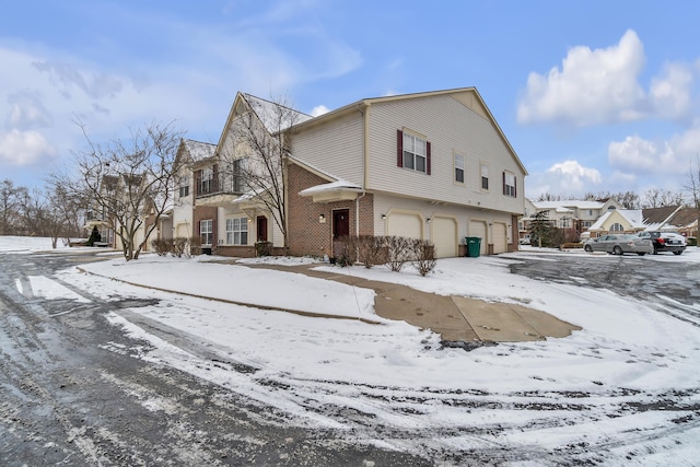 view of snow covered exterior with a garage