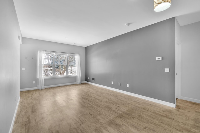 spare room with light hardwood / wood-style flooring