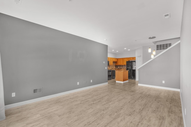 unfurnished living room with light hardwood / wood-style flooring