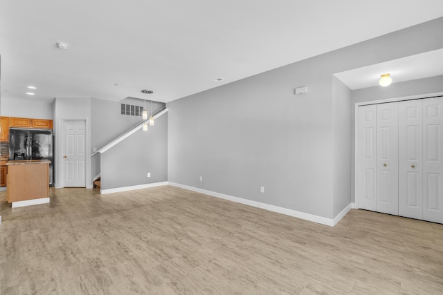 unfurnished living room featuring light hardwood / wood-style floors