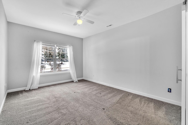 carpeted spare room with ceiling fan