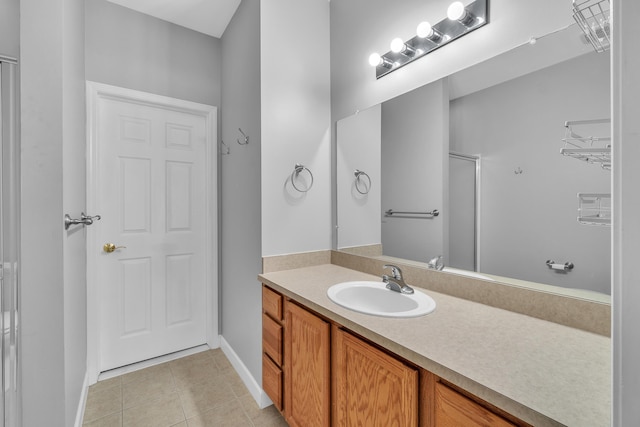 bathroom with vanity, tile patterned floors, and walk in shower