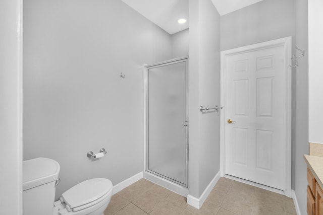 bathroom with vanity, tile patterned floors, toilet, and walk in shower