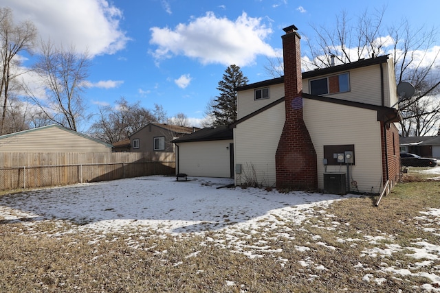 view of snow covered back of property