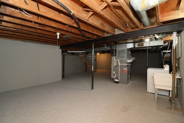 basement featuring washer / clothes dryer, heating unit, and gas water heater