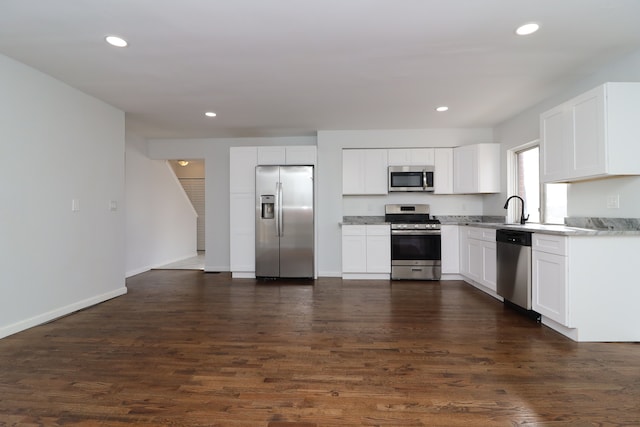 kitchen with white cabinetry, appliances with stainless steel finishes, dark hardwood / wood-style flooring, and sink