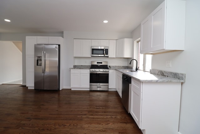 kitchen featuring sink, dark wood-type flooring, white cabinets, and appliances with stainless steel finishes