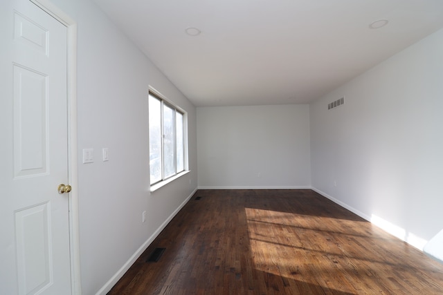 unfurnished room with dark hardwood / wood-style flooring