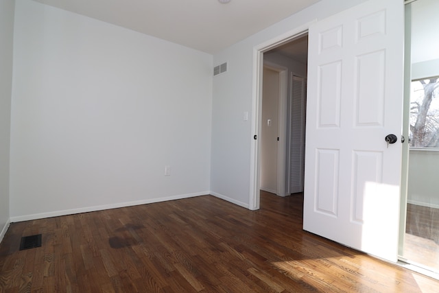 spare room featuring dark hardwood / wood-style floors