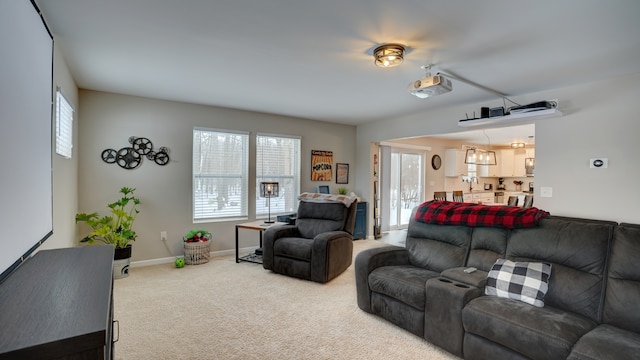 carpeted living room featuring baseboards and plenty of natural light