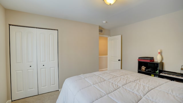 bedroom featuring a closet, visible vents, and light colored carpet