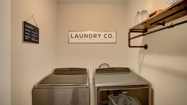 clothes washing area featuring separate washer and dryer