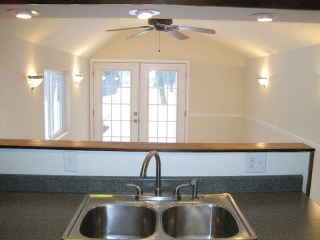 kitchen featuring vaulted ceiling, ceiling fan, and sink