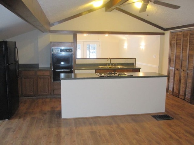 kitchen featuring sink, dark wood-type flooring, ceiling fan, lofted ceiling with beams, and black appliances