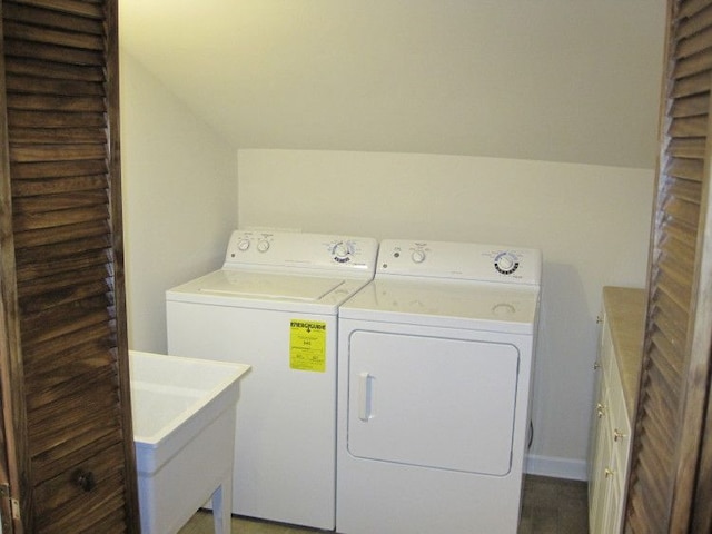 washroom with sink and washing machine and clothes dryer