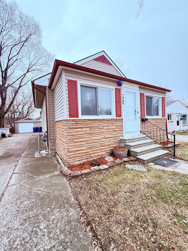 view of front facade featuring a garage and an outdoor structure