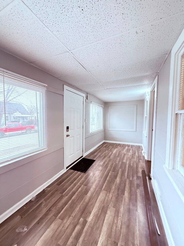 foyer with hardwood / wood-style flooring and a drop ceiling