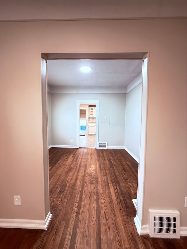 empty room featuring dark wood-type flooring