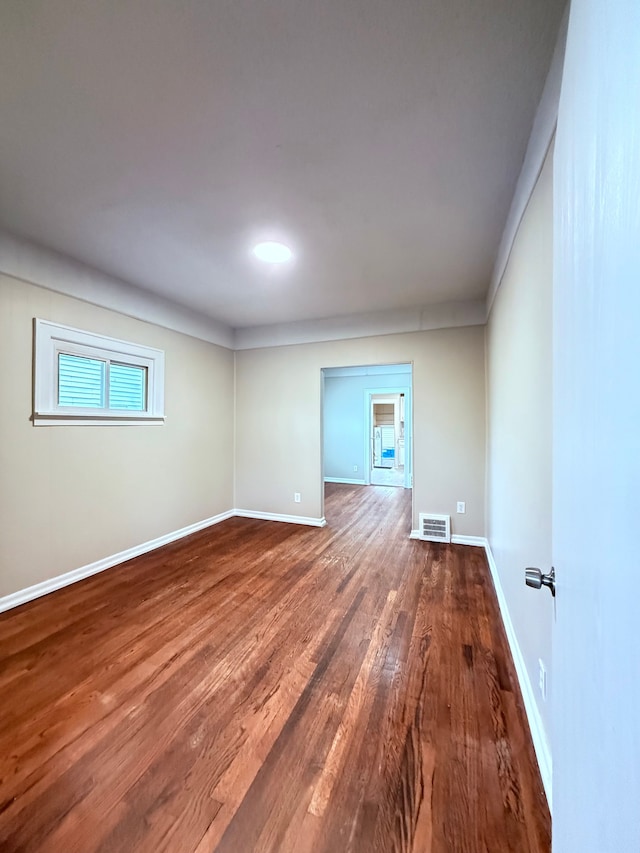 spare room with dark hardwood / wood-style floors