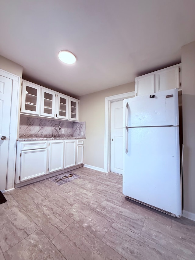 kitchen with white cabinetry and white fridge