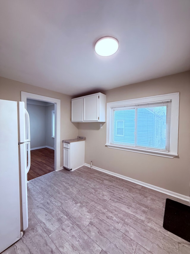 laundry area with light wood-type flooring